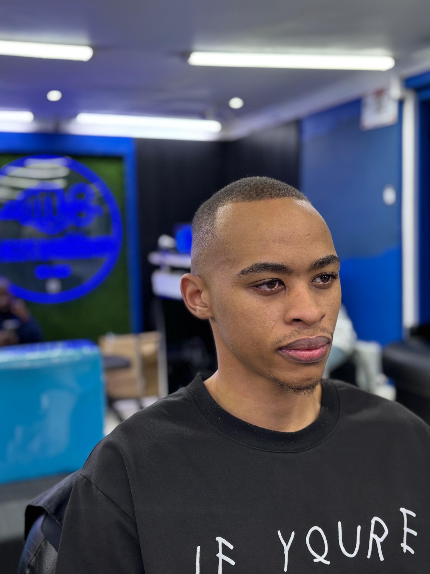 Client showing a clean buzz cut and fade