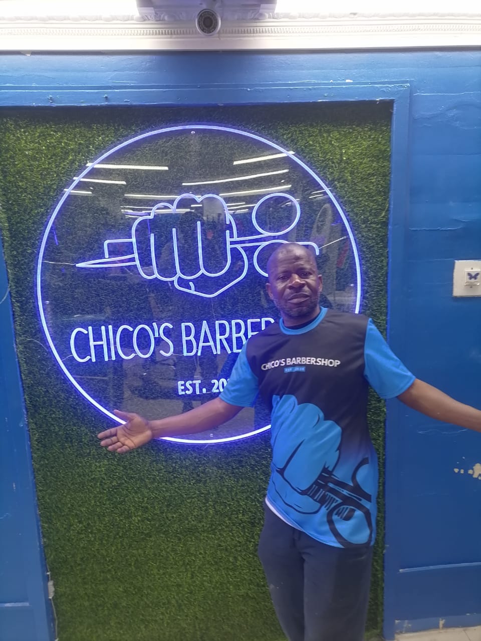 Chico's team member beside the shop's illuminated sign